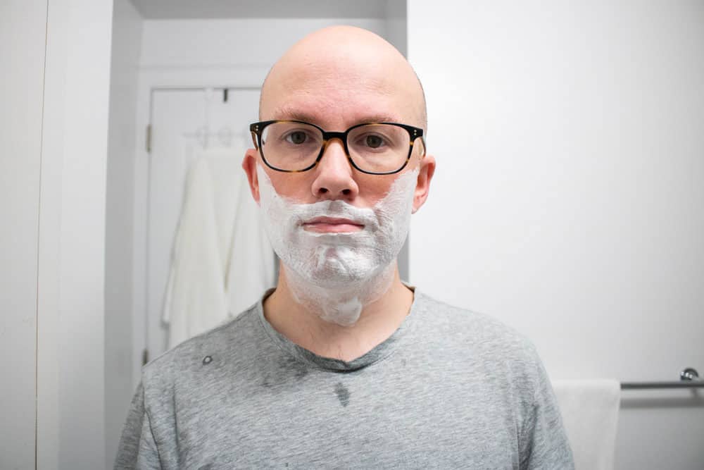 man looking at camera with ghost town barber fully applied to face