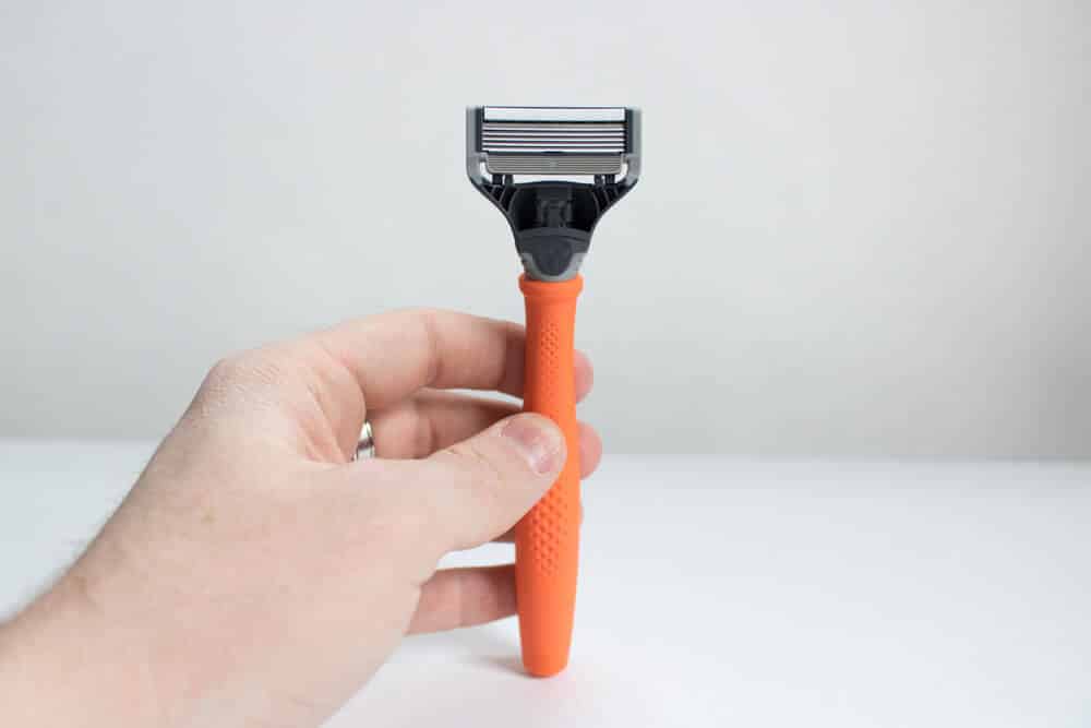man holding harrys razor in hand