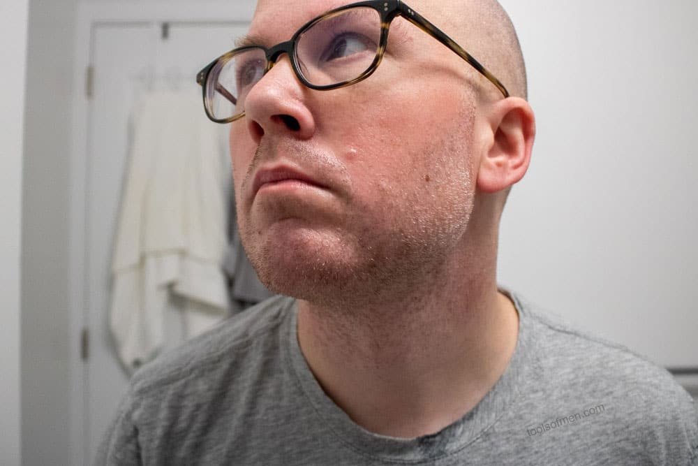 man with taconic pre shave oil on face